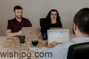 Team members in a conference room with laptops, using mapping tools to enhance collaboration and communication